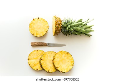 Top View Of Slices Of Fresh Pineapple With Knife Isolated On White