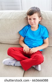 Top View Of Small Boy Crying On Sofa. Dissapointed Small Child 