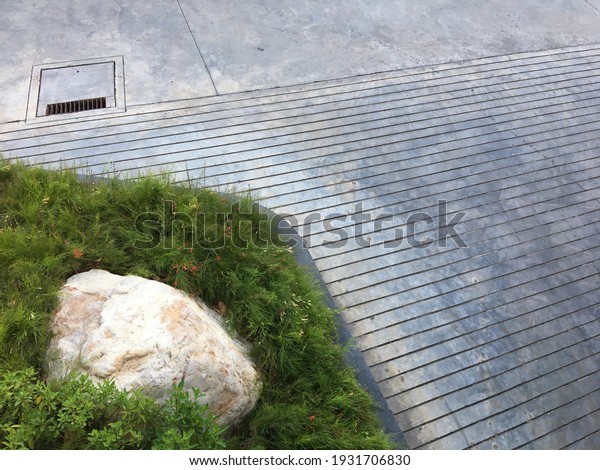 top view of small garden and concrete ramp with\
floor drain