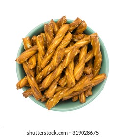 Top View Of A Small Green Bowl Filled With Braided Pretzel Sticks Isolated On A White Background.