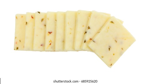 Top View Of A Small Group Of Fresh Pepper Jack Cheese Squares In A Row Isolated On A White Background.