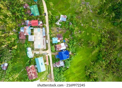 Top view of a small village composed of a few houses and a central open basketball court, in a remote sitio or village near the town of Tubigon, Bohol, Philippines. - Shutterstock ID 2169972245