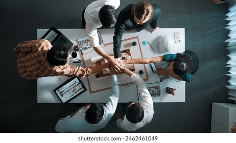 Top view of smart manager clapping hands and putting hands together to celebrate project. Aerial view of architect engineer brainstorming about interior construction. Team work, unity. Alimentation. - Powered by Shutterstock