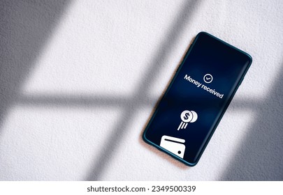 Top view of smartphone transfering money online on screen. Concept of financial transactions with mobile devices. Smartphone screen displaying money transfer confirmation. - Shutterstock ID 2349500339