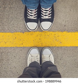 Top View Of Sneakers From Above, Male And Female Feet In Urban Sports Sneakers, Standing At Dividing Line.