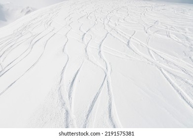 top view of the snow-covered slope of the mountain, traces from skiers and snowboarders, no people - Shutterstock ID 2191575381