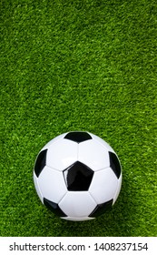 Top View Of Soccer Ball On Green Artificial Grass Feild Background