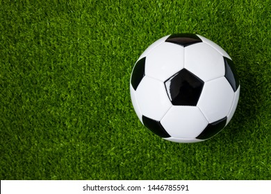 Top View Of Soccer Ball On Green Artificial Grass Feild Background