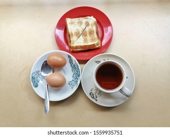 Top View Of Soft Boiled Eggs, Coffee And Toasted Bread. Traditional Breakfast Menu At Many Asian Country.