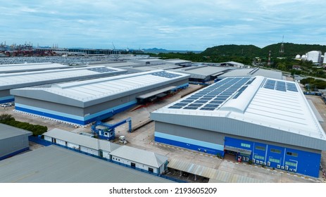 Top View Solar Cell On Warehouse Factory. Solor Photo Voltaic Panels System Power Or Solar Cell On Industrial Building Roof For Producing Green Ecological Electricity. Production Of Renewable Energy. 