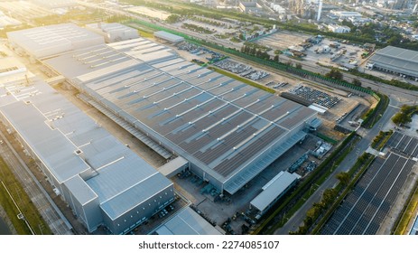 Top view Solar Panels on Warehouse Factory. Solar photo voltaic panels system power or Solar Cell on industrial building roof for producing green ecological electricity. Production of renewable energy