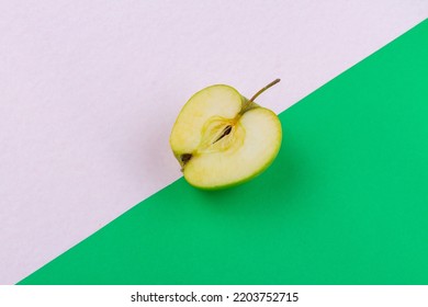 Top View Of Sour Green Apple Half. White And Green Background.