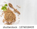 top view of soybean or soya bean in a bowl on white wooden background