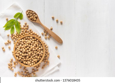 top view of soybean or soya bean in a bowl on white wooden background