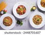Top view, Spaghetti dishes on white background.
