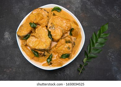 Top View Of Spicy And Hot King Fish Curry With Green Curry Leaf Kerala India. Barracuda Fish Curry With Green Chili, Coconut Milk And Mango Asian Cuisine.