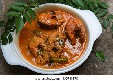 Top View Of Spicy And Hot King Fish Curry With Green Curry Leaf Kerala India. Barracuda Fish Curry With Green Chili, Coconut Milk And Mango Asian Cuisine..