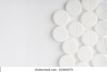 Top view of the Spilled white pills on the white surface