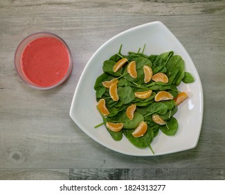 Top View Of A Spinach Salad With Mandarin Oranges And Homemade Raspberry Vinaigrette Dressing.