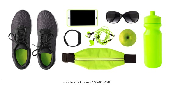 Top view of sport accessories and equipment for training. Running shoes, phone, fitness bracelet etc. isolated on white background - Powered by Shutterstock