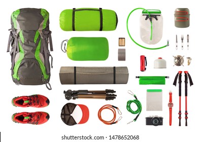 Top view of sport equipment and gear for trekking and camping. Collection of cookware, sleeping bag, travel accessories, etc. isolated on white background