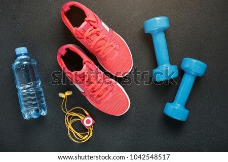 Top view of sportswear, dumbbells and digital devices isolated on grey