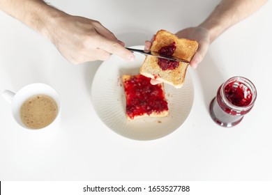 Top View Spreads Cherry Jam On Toast.