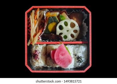 Top View Of A Square Japanese Bento Box With Rice And Vegetables, Isolated On Black Background