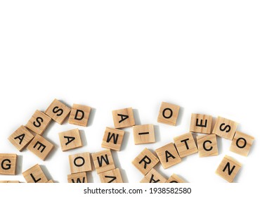 Top view of square wooden tiles with the English alphabet scattered on a white background with space for text. The concept of thinking development, grammar.