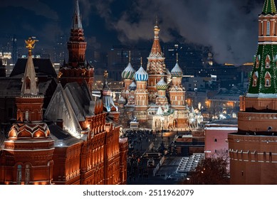 Top view of St. Basil's Cathedral in Moscow at night, with its vibrant domes illuminated, surrounded by historic buildings and the Kremlin towers under a cold winter sky, Russia - Powered by Shutterstock