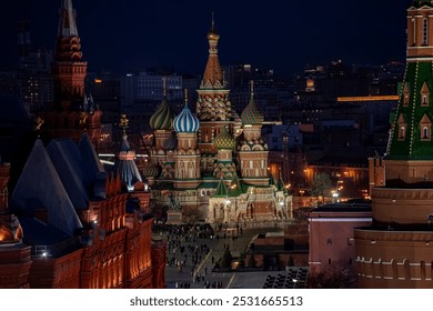 Top view of St. Basil's Cathedral in Moscow at night, with its vibrant domes illuminated, surrounded by historic buildings and the Kremlin towers under a on a spring evening, Russia - Powered by Shutterstock