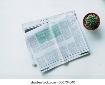 Top View Stack Newspaper And Cactus Pot On Workplace White Desk Of Office