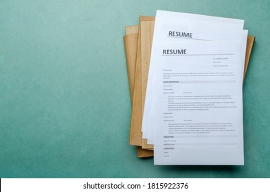 Top view of stack of office documents and cv forms on the desk.Empty space - Powered by Shutterstock