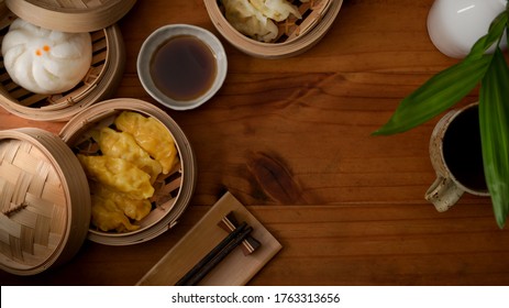 Top view of steamed dumplings serving on bamboo seamer on wooden table with copy space in Chinese restaurants