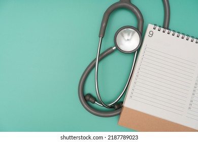 Top View Of Stethoscope And Calendar On The Green Table Background, Schedule To Check Up Healthy Concept