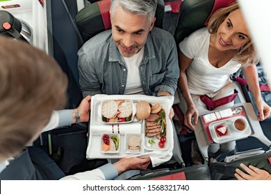 Top View Of Stewardess Holding Food Tray In Plane Stock Photo