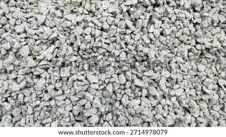 Top view Stone texture background for making concrete for home. Pile of grey stones as background. Crushed stone, commonly referred to as split stone, is often used for making foundations mixed. 