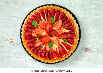 Top View Of Strawberry Flan Cake On Light Mint Background