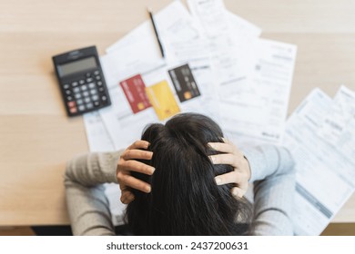 Top view of stressed young asian woman trying to find money to pay credit card debt. - Powered by Shutterstock