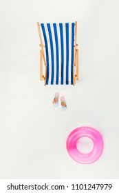 Top View Of Striped Beach Chair, Flip Flops And Inflatable Ring Isolated On White