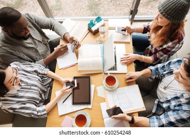 Top view of students studying together - Shutterstock ID 610254248