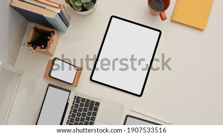 Top view of study table with tablet, laptop, smartphone and stationery in home office room, clipping path