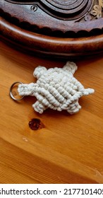 Top View Stunning Handmade Bespoke Off White  Cotton Yarn Turtle Key Chain Lie On Wood