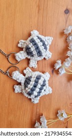 Top View Stunning Handmade Bespoke Off White  Cotton Yarn Turtle  Key Chain Lie On Wood