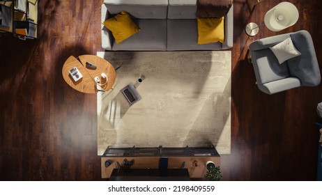 Top View Of A Stylish Apartment With Tastefully Decorated Interior, Coffee Mug, And Laptop On The Floor. No People Conceptual Shot Of A Modern Loft Living Room. Space For Home Office Or Relaxation.