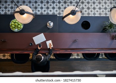 Top View Of Stylish Bar Counter In Modern Flex Office, Kind Brunette Making Notes