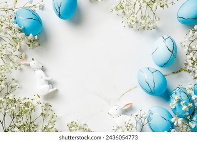 Top view stylish blue Easter eggs with flowers on marble table. Happy Easter greeting card. - Powered by Shutterstock