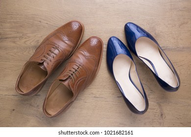 Top View Of Stylish Leather Shoes Of A Man And Of A Woman On Wooden Floor