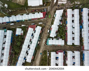 Top View Of A Subdivision Of Rowhouses With White Sheet Metal Roofs For Low To Middle Income Families. At Naic, Cavite, Philippines.