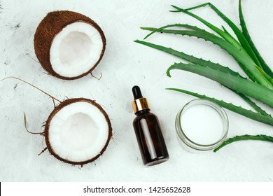 Top View Summer Cosmetics Flat Lay Creme, Oil Bottle,coconut And Aloe Vera Leaves 